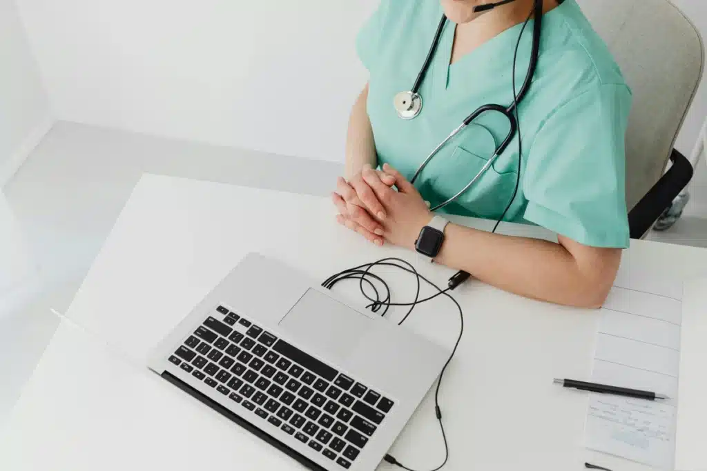 Healthcare virtual assistant working on laptop in a medical office